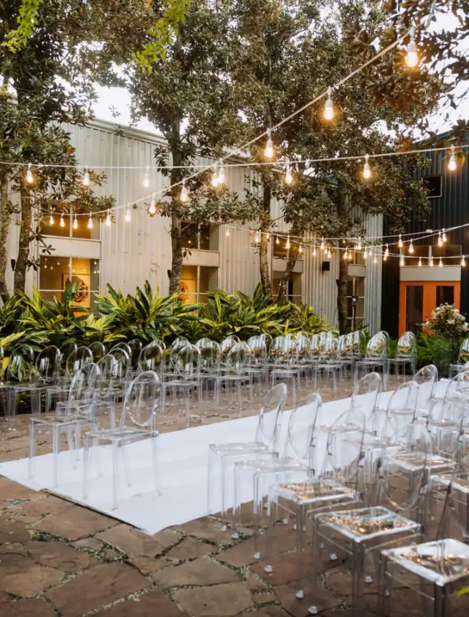 Outdoor event venue courtyard with string lights and ceremony seating